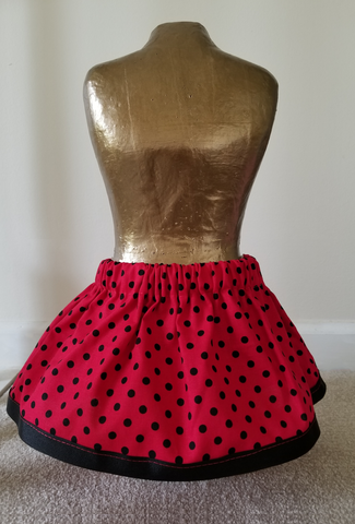 Red and Black polka dot skirt with a Black trim finish